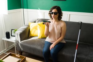 Voice search optimisation helps the blind woman sitting on a couch