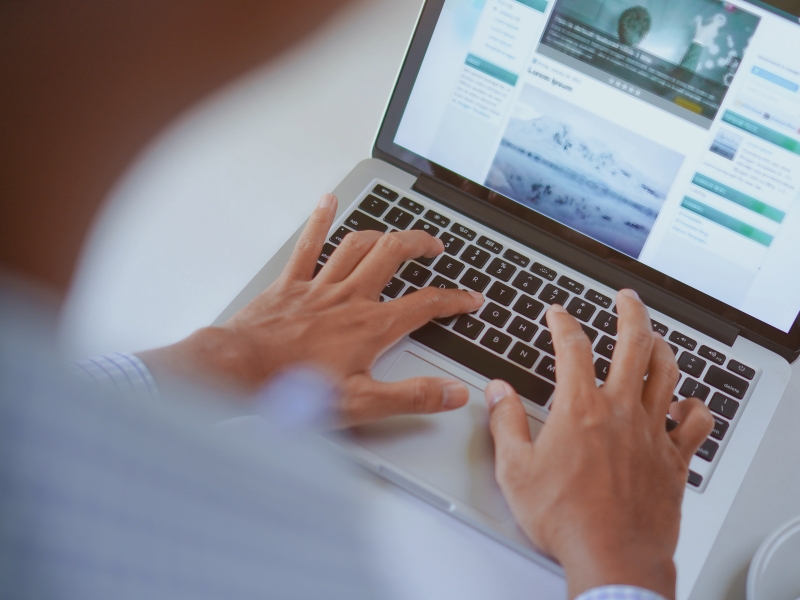 Person typing on a laptop exploring content creation ideas for marketing success.